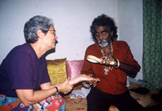 Makul Ghosh, a devotee of Goddess Tara, reads Paola's palm in Calcutta.