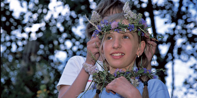 young girl with beautiful floral wreath on her head